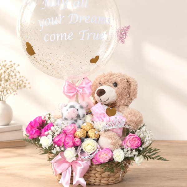 Basket arrangement with pink and white roses, teddy bears, and a clear balloon