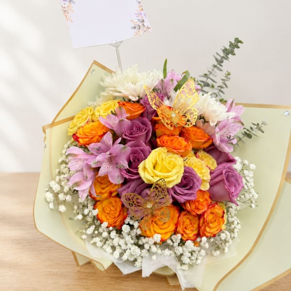 Bouquet of multicolored roses with pink alstroemeria and baby’s breath