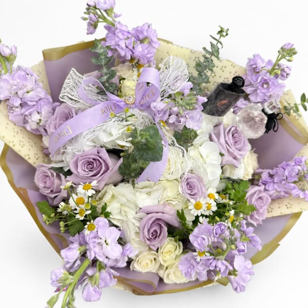 Lavender and white bouquet with roses, hydrangeas, and small daisies