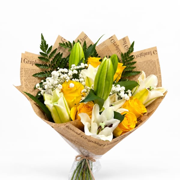 Bouquet of yellow and white roses with white lilies wrapped in newspaper-style paper