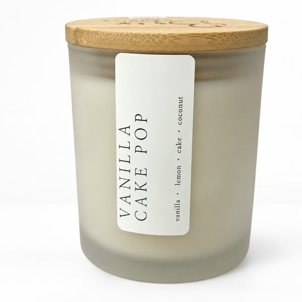 Vanilla cake pop scented candle in a frosted glass jar with a wooden lid