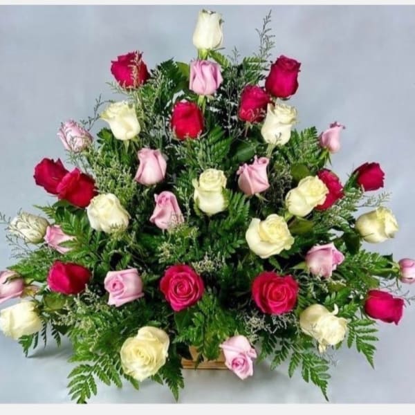 Bouquet of pink, red, and white roses in a low arrangement