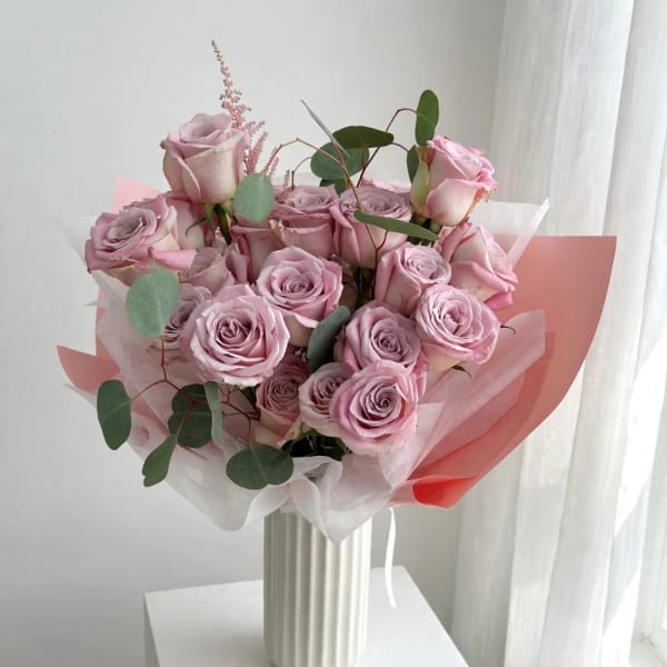Pink rose bouquet wrapped in white and pink paper