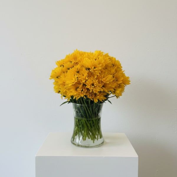 Yellow chrysanthemum bouquet in a clear glass vase