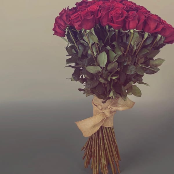 Bouquet of red roses tied with a burlap ribbon