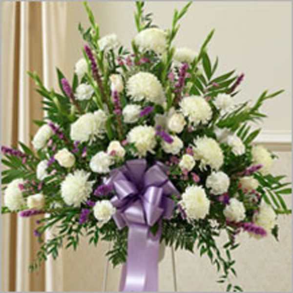 Large white and purple funeral spray with a lavender ribbon
