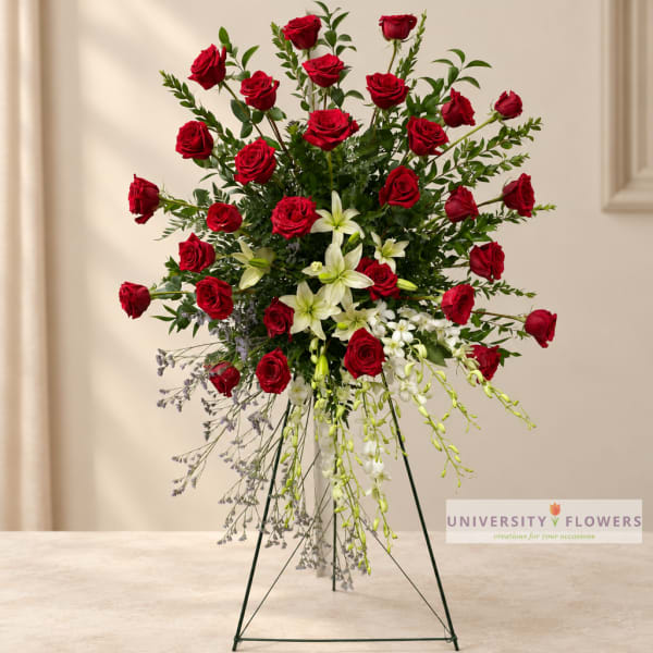 Tall red rose and white lily arrangement on a stand