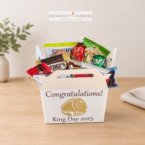Gift basket of assorted snacks in a white box with congratulations text