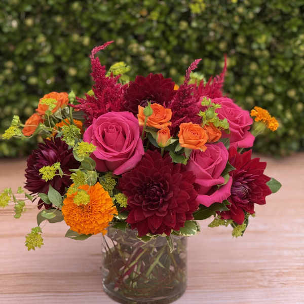 Bouquet of pink and orange flowers in a clear glass vase