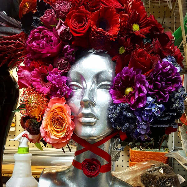 Colorful floral headpiece on a silver mannequin bust
