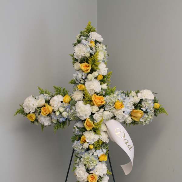 Cross-shaped floral standing spray with white and yellow flowers