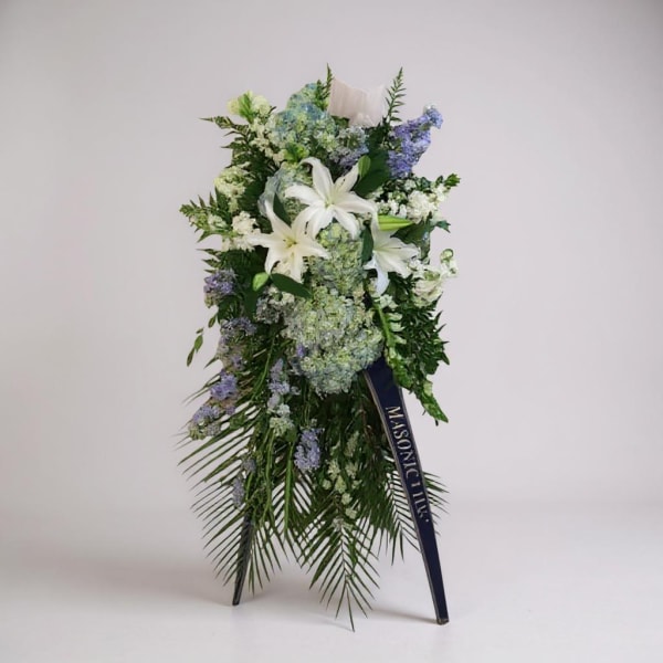 Standing floral spray with white lilies and blue-purple flowers