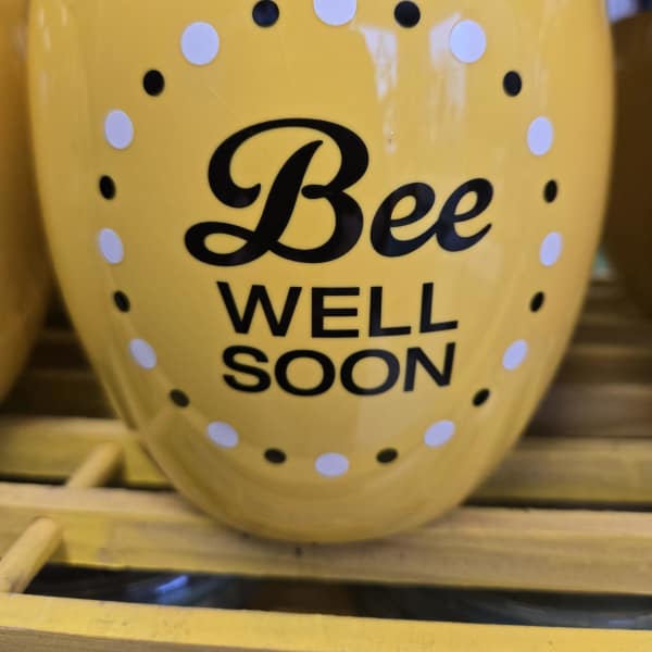 Yellow vase with "Bee Well Soon" text and polka dots