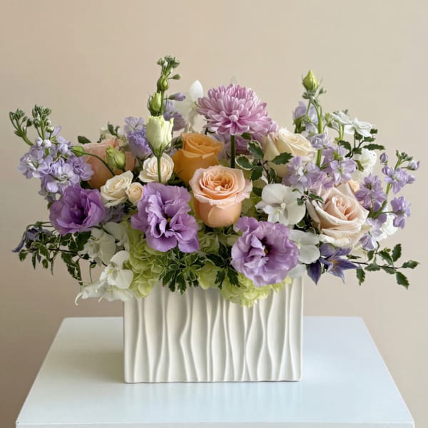 Mixed pastel bouquet in a white textured vase