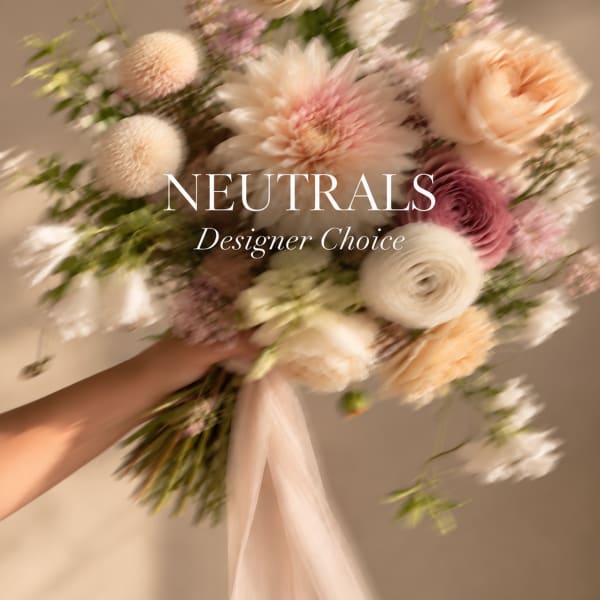 Handheld bouquet of neutral-toned flowers with a ribbon tie