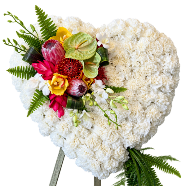 Heart-shaped white floral arrangement with a colorful tropical cluster