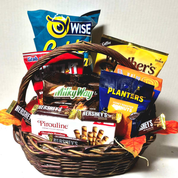 Gift basket filled with assorted chocolates and nuts in a wicker basket