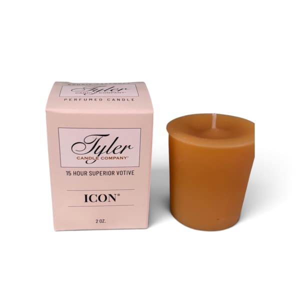 Pink boxed votive candle beside a brown candle