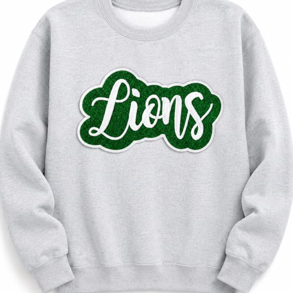 Gray sweatshirt with a green "Lions" patch on the chest