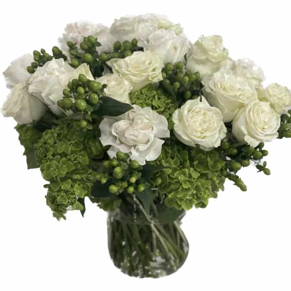 White roses and green hydrangeas in a glass vase