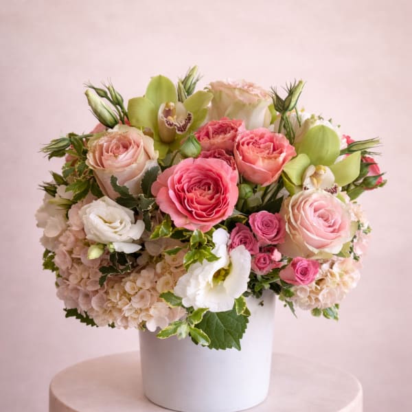 Pink and white floral arrangement in a white vase