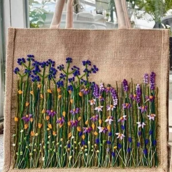 Burlap tote bag with embroidered wildflowers in purple, blue, and yellow
