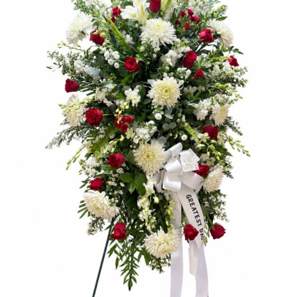 Standing floral spray of red roses and white chrysanthemums with a white ribbon