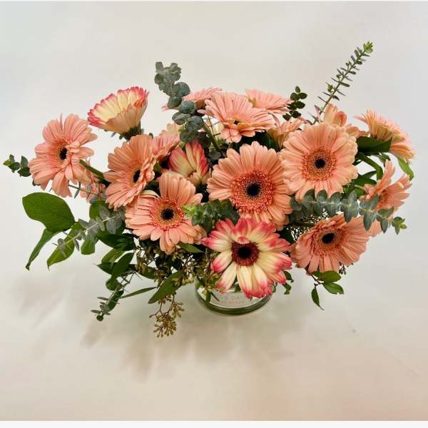 Peach gerbera daisy bouquet in a glass vase