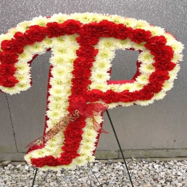 Red and white floral letter P on a stand