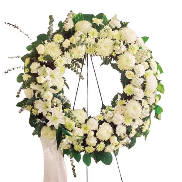 White floral wreath on an easel with a ribbon drape