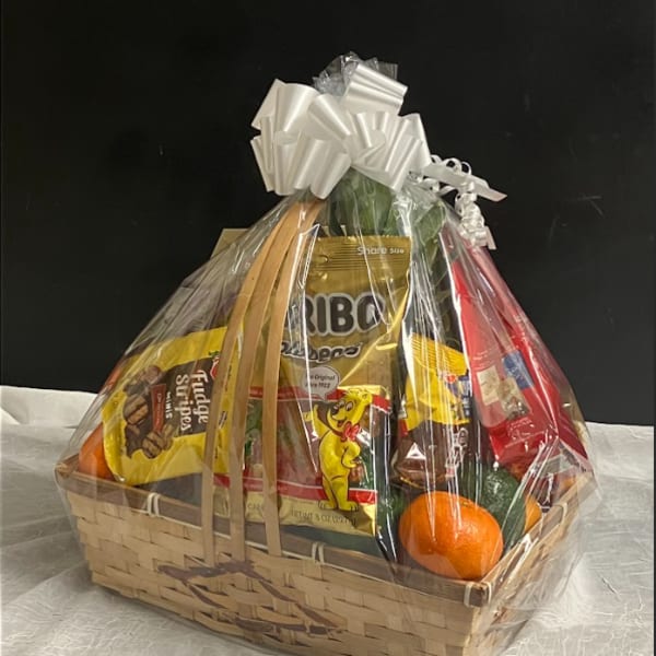 Gift basket with candy and fruit wrapped in clear cellophane
