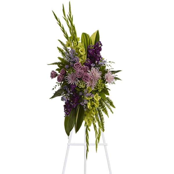 Tall purple and green floral standing spray on an easel