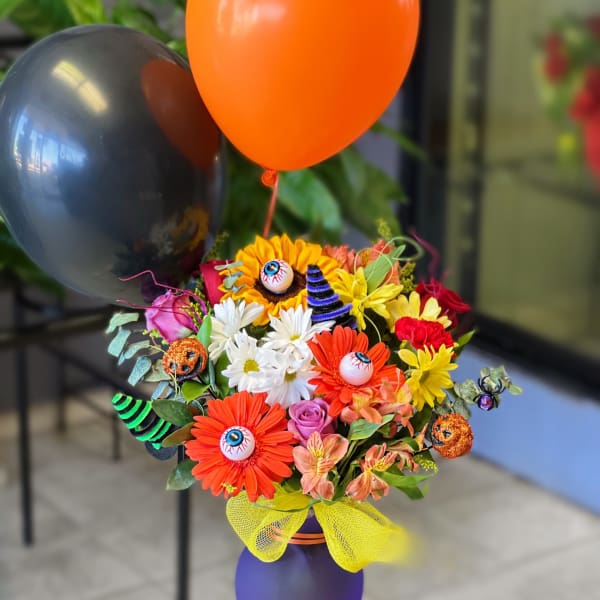 Halloween bouquet with balloons in a purple vase