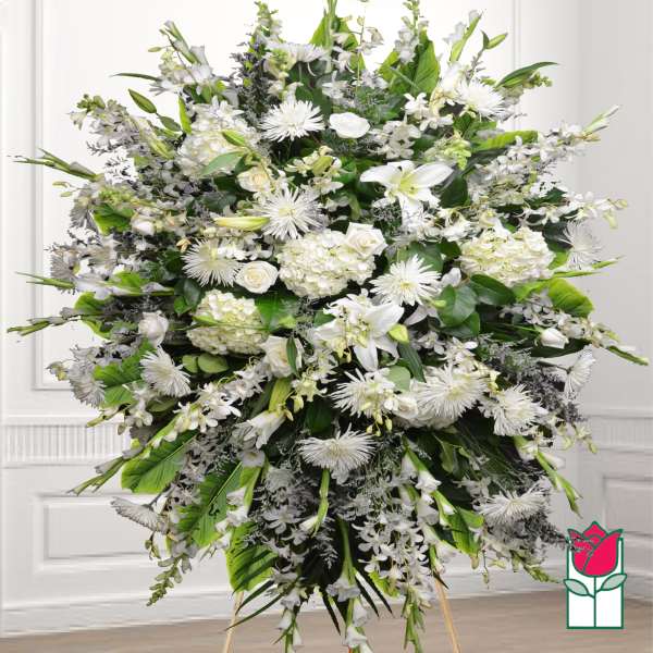 Large white funeral spray with lilies, roses, and chrysanthemums