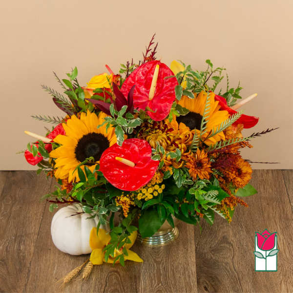 Bright mixed bouquet with sunflowers, red anthuriums, and autumn flowers in a vase