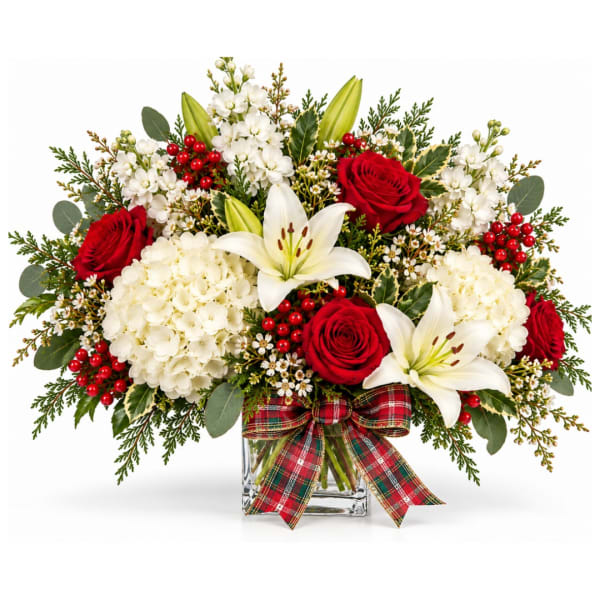 Red roses and white lilies in a glass vase with a plaid bow