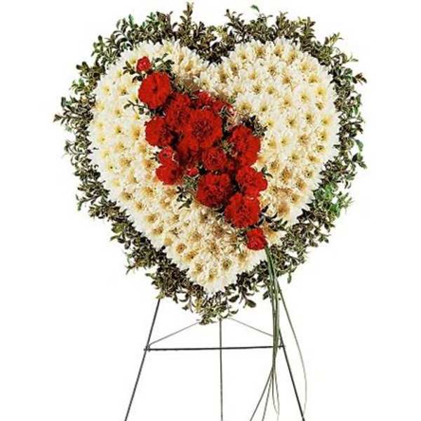 Heart-shaped floral standing spray with red and white flowers on an easel