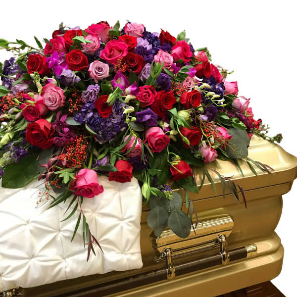 Large floral spray of red, pink, and purple roses on a gold casket