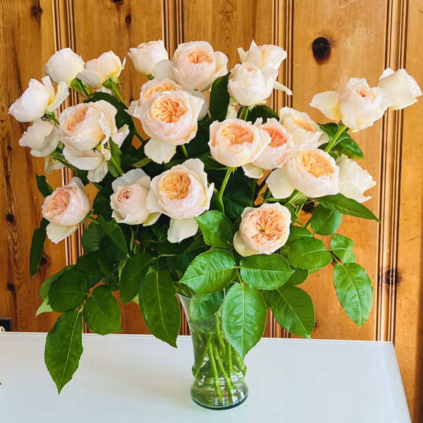 Bouquet of pale peach roses in a clear glass vase