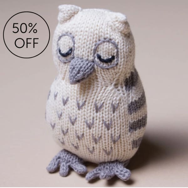 Knitted owl figurine with closed eyes and gray accents