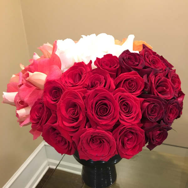 Bouquet of red and pink roses in a black vase
