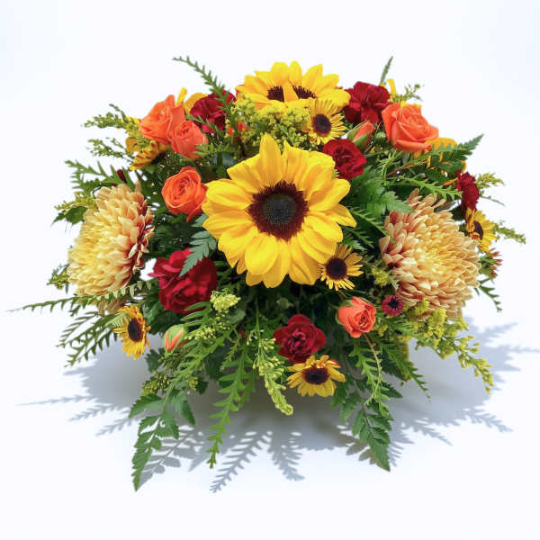Mixed bouquet with sunflowers, orange roses, and red blooms