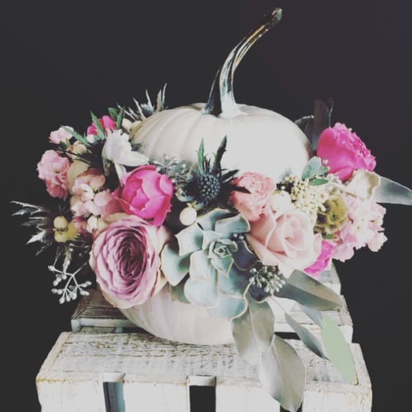 White pumpkin centerpiece with pink and lavender flowers