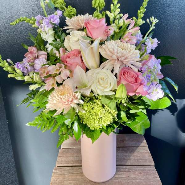 Pink and white mixed bouquet in a tall blush vase