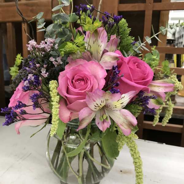 Pink roses and alstroemeria in a clear glass vase