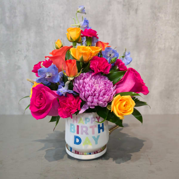 Colorful mixed bouquet in a birthday mug vase