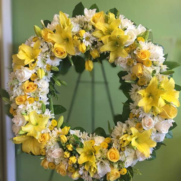 Yellow and white floral wreath with roses and lilies