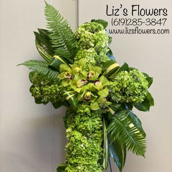 Green floral standing cross with orchids and hydrangeas