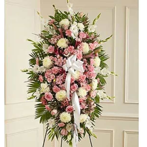 Standing floral spray with pink and white flowers and a white ribbon