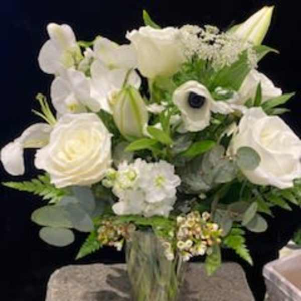 White floral bouquet in a clear glass vase